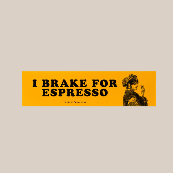 The RAVE COFFEE Car Bumper Sticker is a rectangular, yellow vinyl decal with a glossy finish. It features bold black "I BRAKE FOR ESPRESSO" text and a vintage-style graphic of a woman holding a cup.