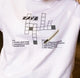White t-shirt with a crossword-style graphic and text on a plain background