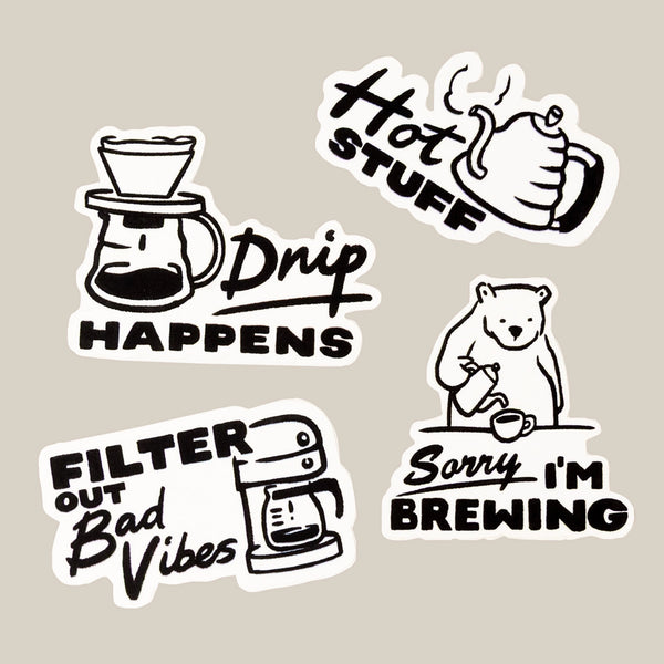 The Drip Happens Sticker Pack by RAVE COFFEE features four black and white vinyl coffee stickers—Drip Happens, Hot Stuff, Filter out Bad Vibes, and Sorry I’m Brewing—perfect for rave-loving coffee fans.
