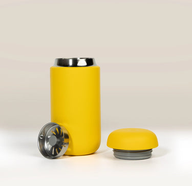 Yellow Fellow Carter Move Mug (12oz) with its lid and a metal splash guard removed.