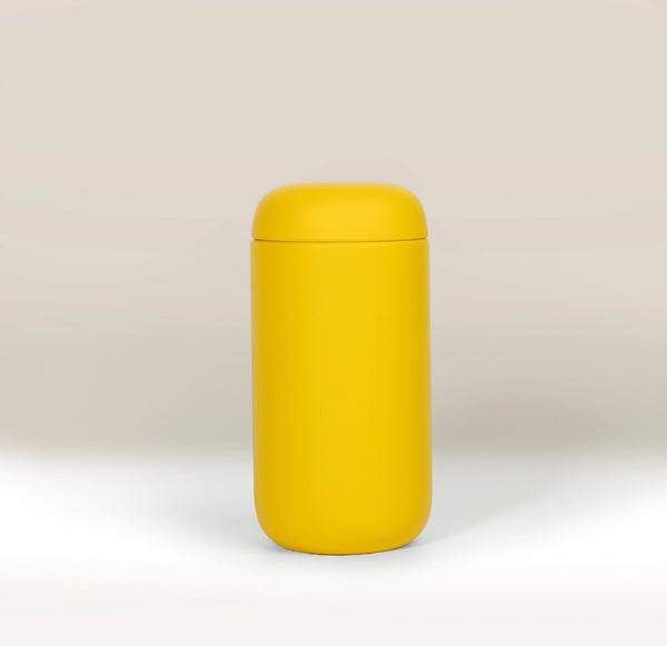A bright yellow Fellow Carter Move Mug (12oz) with a matching lid.
