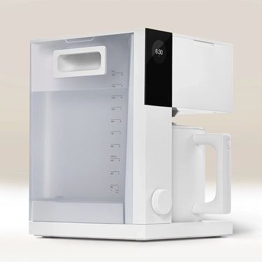 The Fellow Aiden Precision Drip Filter Coffee Maker by Fellow features a sleek white minimalist design, large water reservoir, digital display set to 6:30, matching carafe, and customizable temperature controls for perfect brewing on a neutral background.