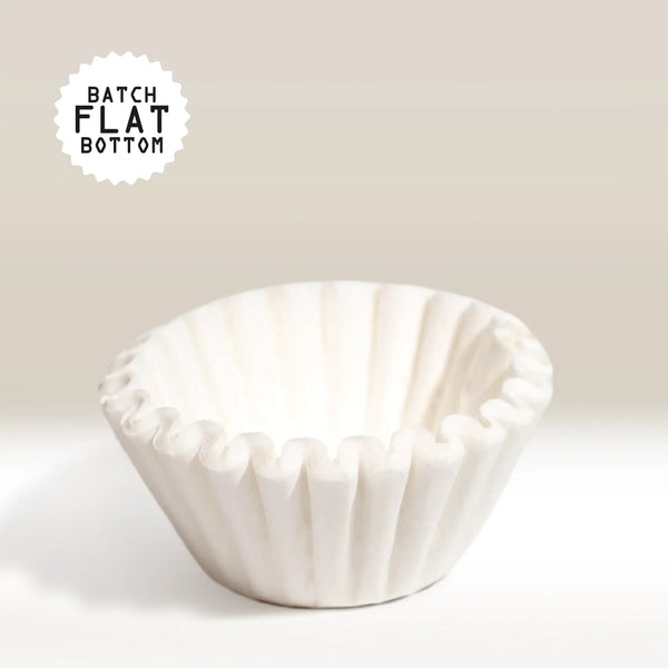A flat-bottomed, white Fellow Aiden Precision Coffee Maker Brew Filter Paper with ruffled edges sits on a neutral background. "Batch Flat Bottom" text appears in the top left corner.