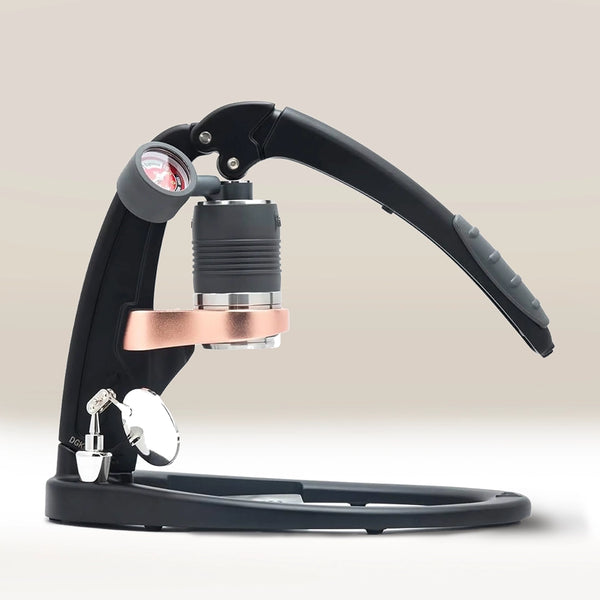 The Flair PRO 3 Espresso Maker by Flair, featuring a pressure gauge and copper accent, is displayed on a white surface with a light beige background.