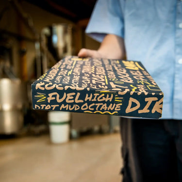 A photo of person holding a RAVE branded coffee gift box.