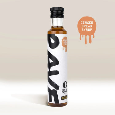 A bottle of RAVE COFFEE Rave Coffee Syrups stands upright with a white and black label. To the right, a brown paint splatter graphic reads Ginger Bread Syrup. The background features beige and white tones.