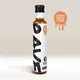 A bottle of RAVE COFFEE Rave Coffee Syrups stands upright with a white and black label. To the right, a brown paint splatter graphic reads Ginger Bread Syrup. The background features beige and white tones.
