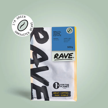 A 500g bag of RAVE COFFEE Brazil Guima Estate Green Coffee Beans stands upright on a light green background, displaying eco-friendly and 1% For The Planet logos with bold, modern packaging.