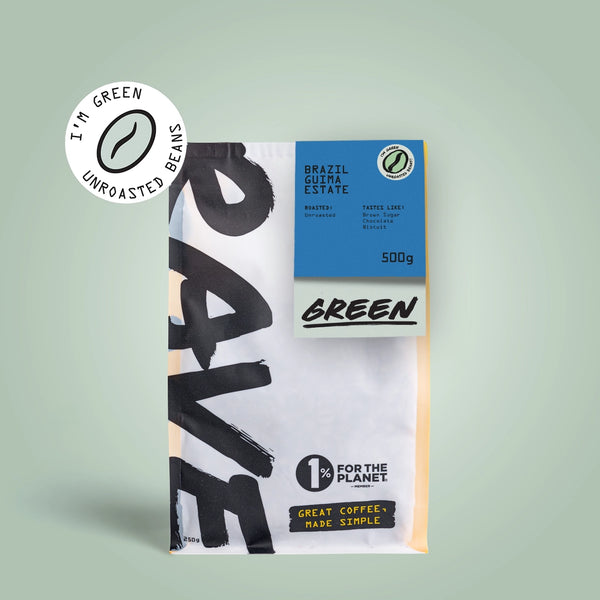 A 500g bag of RAVE COFFEE Brazil Guima Estate Green Coffee Beans stands upright on a light green background, displaying eco-friendly and 1% For The Planet logos with bold, modern packaging.