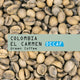 A close-up of unroasted coffee beans with an overlay reading 
