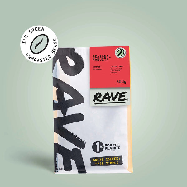 A RAVE COFFEE bag labeled Seasonal Robusta Green Coffee Beans features a red label, 500g of unroasted beans, a circular "I'm green unroasted beans" badge, and "1% for the planet" text—ideal for home roasting.