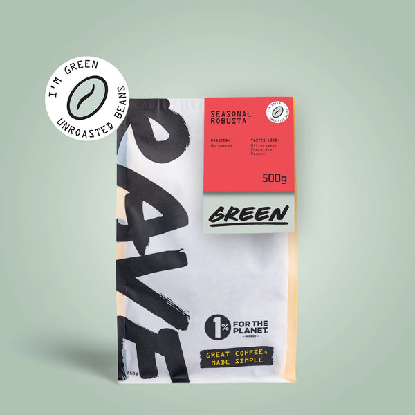 A RAVE COFFEE bag labeled Seasonal Robusta Green Coffee Beans features a red label, 500g of unroasted beans, a circular "I'm green unroasted beans" badge, and "1% for the planet" text—ideal for home roasting.