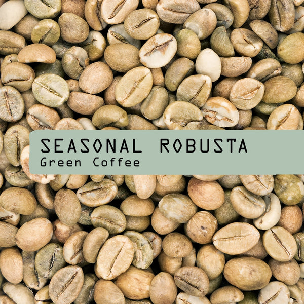 A close-up of unroasted coffee beans with a green label reading "Seasonal Robusta Green Coffee Beans" from RAVE COFFEE, ideal for home roasting enthusiasts.