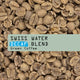 Swiss Water Decaf Green Coffee with text overlay on a background of coffee beans