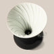 Top view of the Hario Switch V60 Ceramic Immersion Dripper (Size 02) by Hario, featuring spiral ridges on a black base and clear handle, set against a light beige background.