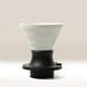 The Hario Switch V60 Ceramic Immersion Dripper (Size 02) features a white fluted ceramic design atop a black plastic base, showcasing Hario’s signature V60 style against a neutral background.