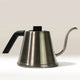 The Hario Tetsu Kasuya Pour Over Kettle by Hario features stainless steel construction, a black handle, and a long curved spout—perfect for precision coffee brewing. Photographed on a neutral background.
