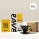 The Hario V60 Dripper Filter Coffee Gift Set by Hario includes a black V60 dripper, yellow brew guide booklet, Rave’s signature blend coffee, and packaging—all shown on a neutral background with a Small (1 cup) label.