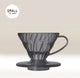 A Hario V60 Black Plastic Coffee Dripper with handle, crafted for one-cup filter coffee brewing, is set against a light beige background. 