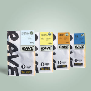 Four RAVE COFFEE bags from the Home Roasters Green Coffee Selection Pack stand side by side, each featuring a vibrant label with origin, variety, and 500g weight—perfect for home roasters seeking green coffee.