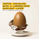 A large RAVE COFFEE Coffee Chocolate Easter Egg, caramel-colored, rests in a half-open foil wrapper on a white saucer. Above it, bold yellow and black text reads: 