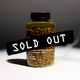 A plastic bottle filled with coffee beans is labeled with various details. A bold black banner across the bottle reads SOLD OUT in large white letters, highlighting the popularity of RAVE COFFEE’s #0005 Colombia Jairo Arcila Peach Co-ferment – 150g specialty coffee.