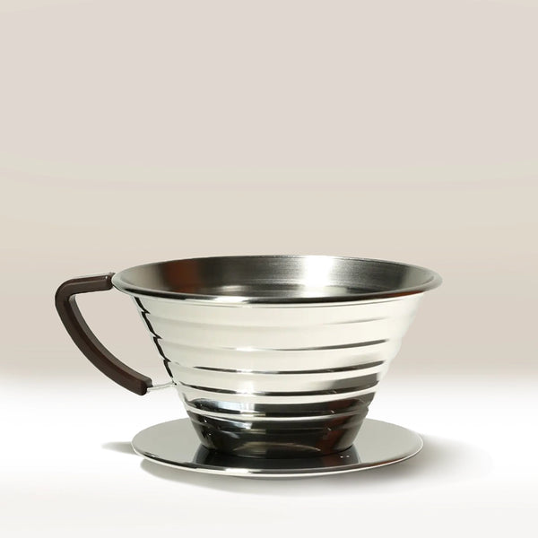 The Kalita Wave 185 Steel Coffee Maker by Kalita features a stainless steel ridged design with a black handle on a round base, set against a light background—ideal for brewing your next pour-over coffee.