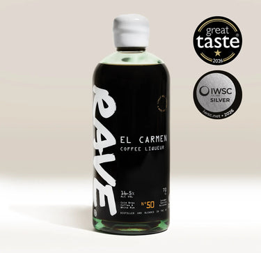 A bottle of RAVE COFFEE Coffee Liqueur, made with single-origin coffee beans and English white rum, stands upright. Beside it are two award badges: Great Taste 2026 and IWSC Silver 2026. The bottle showcases bold white and gold text on a dark label.