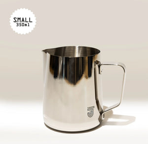 The Crema Pro Milk Steaming Jug or Pitcher, 12 OZ/350ml, has a handle and “SMALL 350ml” labeled in the top left. The Crema Pro logo appears on the lower front of this versatile stainless steel latte art pitcher.