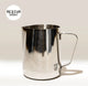 The Crema Pro Milk Steaming Jug, 20 OZ / 600ml, features a shiny stainless steel design with handle and small logo near the base. Perfect for latte art, it sits on a neutral background with 