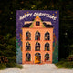 RAVE COFFEE Coffee Chocolate Advent Calendar illustrated as a multi-story house containing coffee and handmade chocolates, set against a backdrop of pine branches and snow.