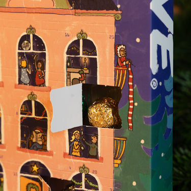 A RAVE COFFEE Coffee Chocolate Advent Calendar with a gold-foil-wrapped Rave Signature Blend coffee chocolate peeking out from an open numbered window.