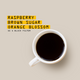 A top-down view of a white ceramic coffee mug filled with black coffee on a warm beige background, next to yellow text that reads 'RASPBERRY BROWN SUGAR ORANGE BLOSSOM AS A BLACK FILTER'.