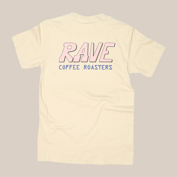 The Pink Rave | T-Shirt by RAVE COFFEE is a cream-colored unisex cotton shirt with bold pink "RAVE" and blue "COFFEE ROASTERS" on the back, from our signature Rave Coffee t-shirts collection.