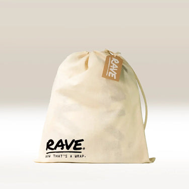 A cream-colored Cafe Gift Bag with a brown tag is shown against a neutral background. This reusable bag features the Cafe logo and the phrase NOW THAT'S A WRAP. printed near the bottom.