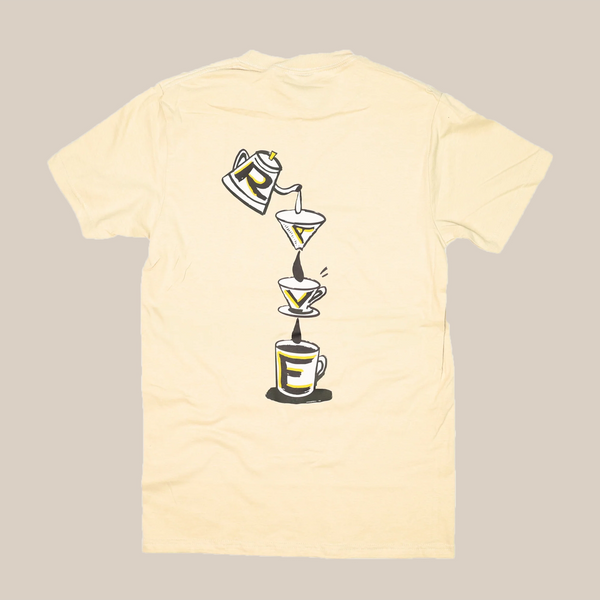 The Rave V60 T-Shirt by RAVE COFFEE is a cream unisex cotton tee with a back print of a coffee pot pouring into two filters and a cup, forming the word "RARE" vertically in bold yellow and black. Inspired by Rave Coffee t-shirts.