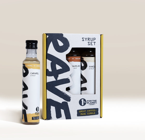 A bottle of caramel syrup next to a Best Selling Syrup Set box containing hazelnut and vanilla flavoured coffee syrups.