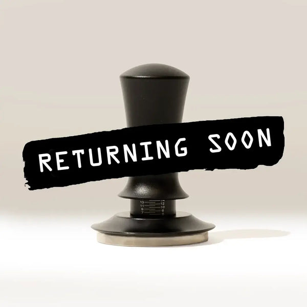 A Self Levelling Spring Tamper by RAVE Coffee sits on a light surface with a black banner reading "RETURNING SOON" in white, ideal for espresso tamping and use with 54mm filter baskets.