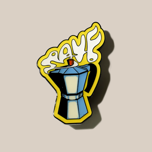 The RAVE Coffee Stove Top Pin Badge is a colorful enamel pin featuring a moka pot with yellow steam spelling "CAFÉ" above it on a beige background—the perfect accessory for any coffee enthusiast.
