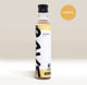 An upright bottle of Rave Coffee Syrups by RAVE COFFEE with a modern white and yellow label sits on a light background. A caramel-colored badge marked CARAMEL appears in the top right corner. Perfect for coffee syrup lovers.
