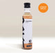 A clear bottle of Rave Coffee Syrups by RAVE COFFEE with a black cap and white label is displayed. An orange badge in the top right corner reads GINGERBREAD. Perfect for adding to your Rave Coffee, this delicious gingerbread-flavoured syrup stands upright on a light surface, ready to enhance your favourite drinks.