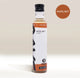 A bottle of RAVE COFFEE Rave Coffee Syrups Hazelnut flavour, featuring a black cap and white label printed with “Hazelnut Syrup” and the 1% for the Planet logo. A brown badge above highlights “Hazelnut.” Expertly blended in the UK, this syrup is perfect for enhancing your favourite coffee drinks and is an essential addition to any collection of coffee or flavoured syrups.