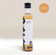 A bottle of RAVE COFFEE’s Rave Coffee Syrups with a black cap and minimalist label stands upright, featuring a TOFFEE badge in the upper right corner. Perfect for enhancing your favourite drinks, this UK blended toffee syrup is part of RAVE COFFEE’s premium range of flavoured syrups ideal for coffee lovers. The label also displays 1% FOR THE PLANET.