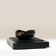 Black coffee doser on digital scales with a neutral background