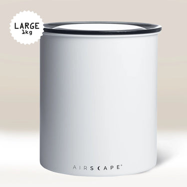 The Planetary Design White Airscape Coffee Storage Container is a large, white, cylindrical canister with a black rim and “LARGE 1 kg” label. It keeps coffee fresh with its oxygen-free seal and features “AIRSCAPE” branding near the bottom.
