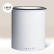 The Planetary Design White Airscape Coffee Storage Container is a large, white, cylindrical canister with a black rim and “LARGE 1 kg” label. It keeps coffee fresh with its oxygen-free seal and features “AIRSCAPE” branding near the bottom.